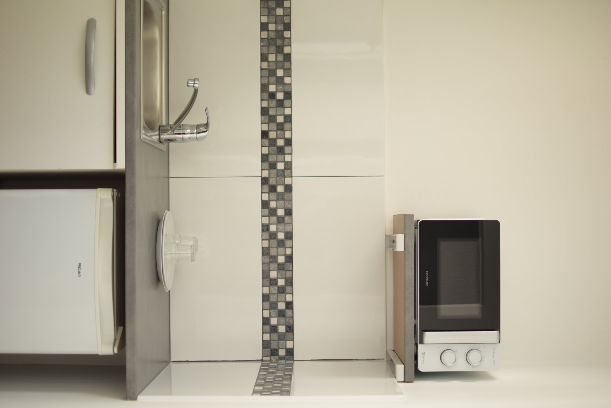 Kitchenette du studio avec micro-ondes, réfrigérateur et ustensiles